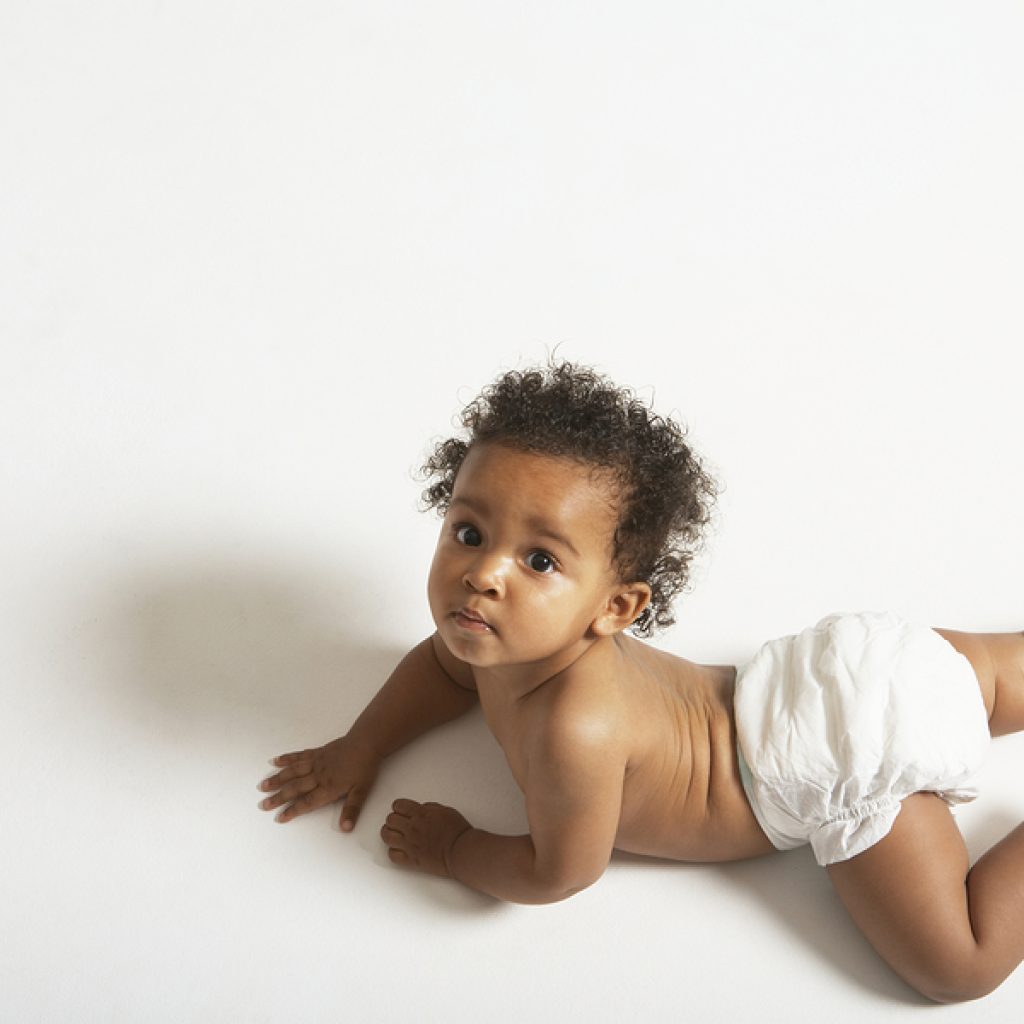 High Angle Portrait Of Cute Baby Crawling On White Background
