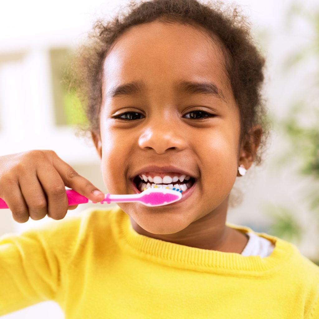 Little Beautiful African Girl Brushing Teeth