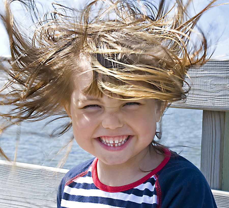 windy hair, a girl on the beach when it blows hard