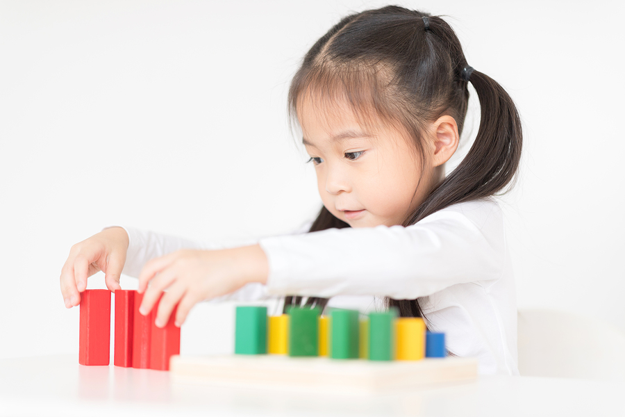 little girl play with blocks. educational toys for preschool and