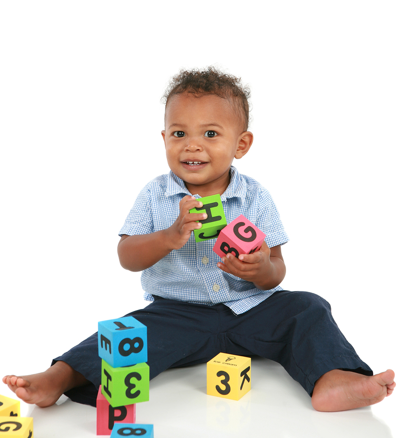 adorable one year old african american boy playing toy isolated