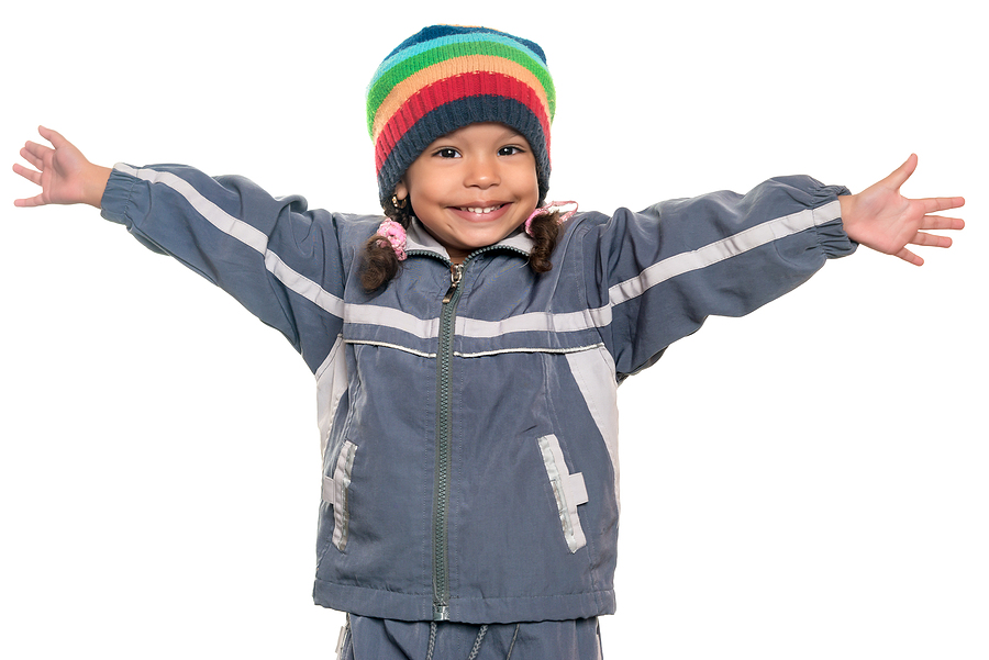 happy mixed race little girl wearing a colorful beanie hat offer